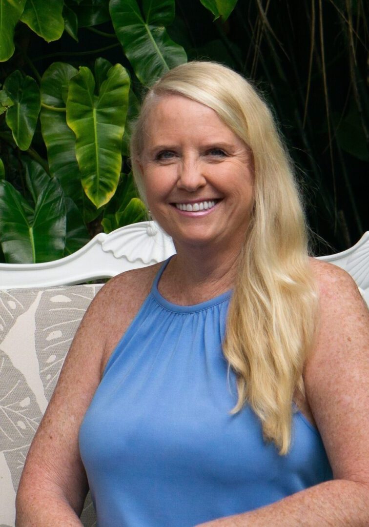 A woman sitting on top of a white chair.